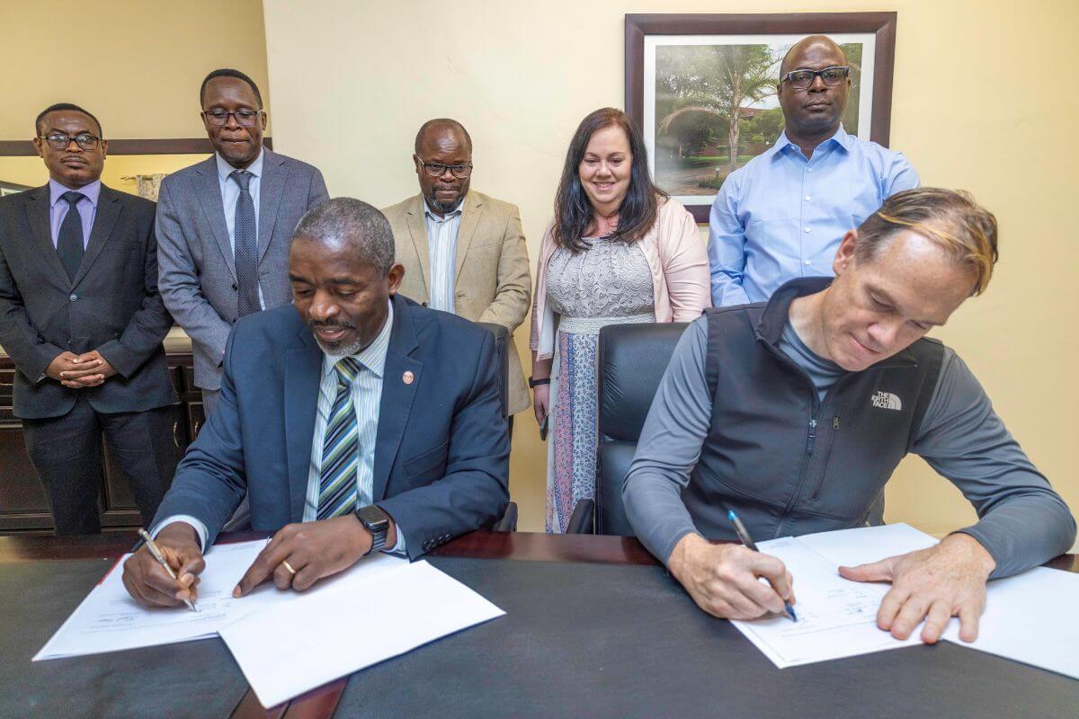 Africa University’s Vice Chancellor Reverend Professor Peter Mageto (Left) and UMCom General Secretary Dan Krause (Right) sign to establish the partnership. (Photo courtesy of Africa University)