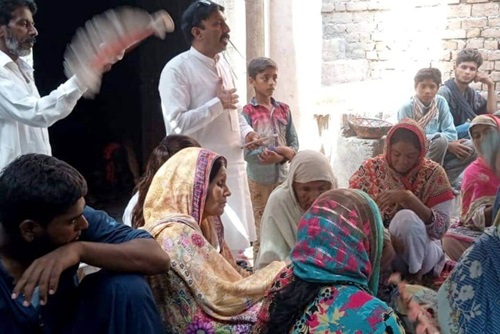 Insar Gohar, a National in Mission worker in Pakistan, meets with families in one of their homes to listen to their concerns as they process their grief. Photo courtesy of Insar Gohar.