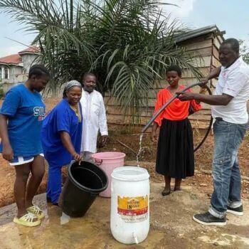 Community members learn how to use and maintain the new water pumping facility, Minkoameyos, Cameroon. Photo courtesy of UMC Cameroon.