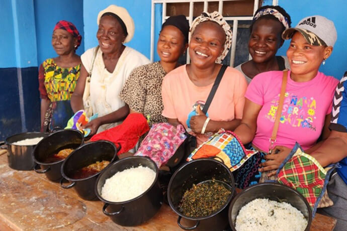 Recipients of sun-powered ovens learn to adapt local recipes to the new cooking method. This photo was taken during a United Methodist Solar Oven Partners workshop for new oven owners in Bo, Sierra Leone, in December 2025. Photo courtesy of Solar Oven Partners.
