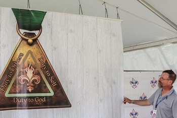 Steven Scheid prepares for the United Methodist Men and Scouting Ministries booth.  Photo courtesy of Bob Vogt.