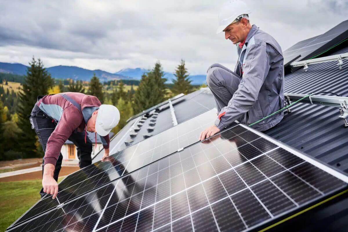 Solar installers working on a rooftop. Photo courtesy of GBGM.