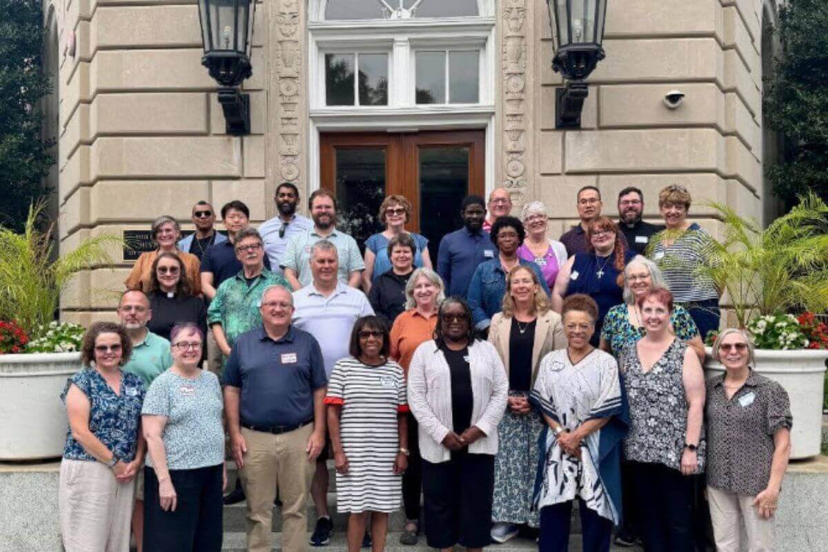 Participants in the Northeastern Jurisdictional Gathering for Justice and Peace gather outside the United Methodist Building.
