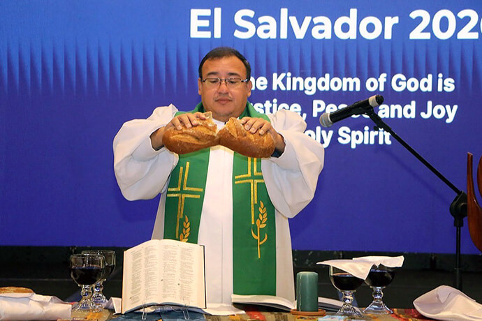 Bishop Juan de Dios Peña, episcopal leader of the Evangelical Methodist Church of El Salvador, serves Holy Communion during a worship service at the World Methodist Council meeting held Aug. 12-16 in San Salvador, El Salvador. Photo courtesy of the Evangelical Methodist Church of El Salvador.