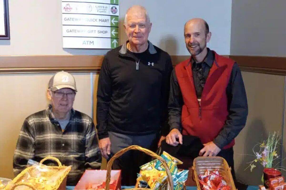 Rev. Bruce Maxwell (far right), an endorsed chaplain serving at the Breezewood, Pennsylvania, travel plaza, joins volunteers staffing a hospitality table that offers refreshments, devotionals, and care packages as part of a ministry of presence, prayer, and care for travelers and employees. Photo by Bruce Maxwell