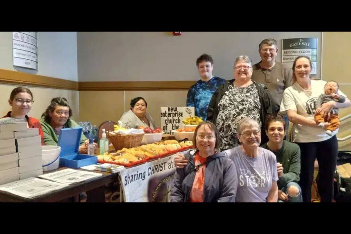 Volunteers serve travelers and employees at a hospitality table stocked with refreshments, devotionals, and care packages. Through weekly Bible studies and an ongoing presence at the travel plaza, Rev. Bruce Maxwell, a UMEA chaplain, creates opportunities for fellowship and spiritual support. Photo by Bruce Maxwell 