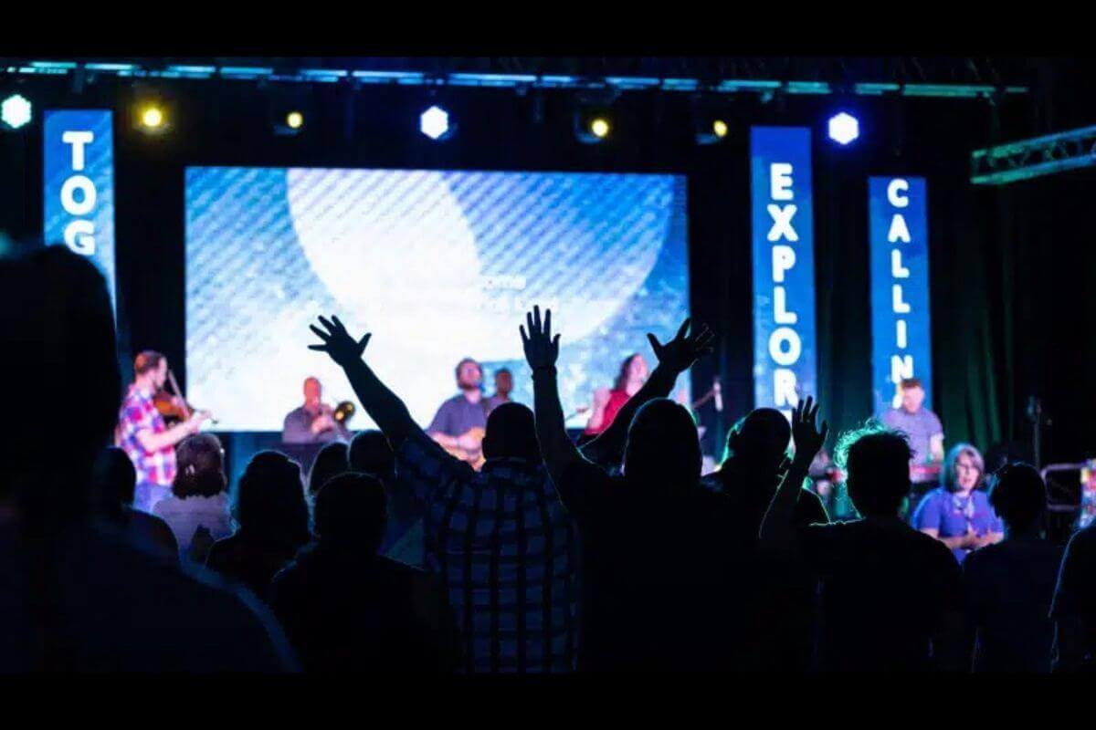 Hands raised in worship during the opening service of EXPLORATION 2019, where young adults from across The United Methodist Church came together to explore vocation, ministry and God’s call on their lives. Photo by Joseph McBrayer