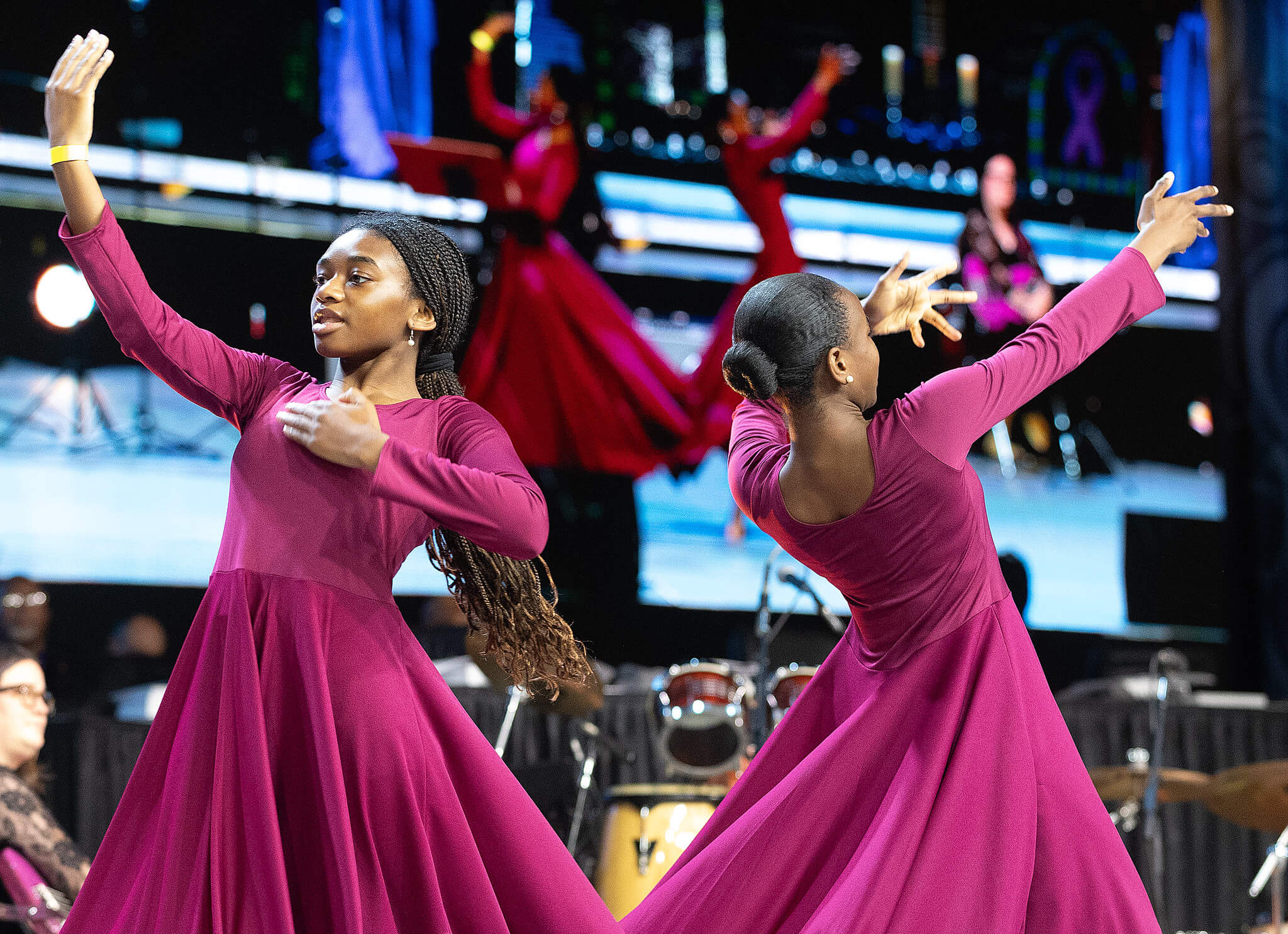 Mackenzy Sanders (left) and Carter Mallory, members of the Expressions of Praise dance group of St. Mark's United Methodist Church in Charlotte, N.C., dances during morning worship at the 2024 United Methodist General Conference in Charlotte. Photo by Mike DuBose, UM News..